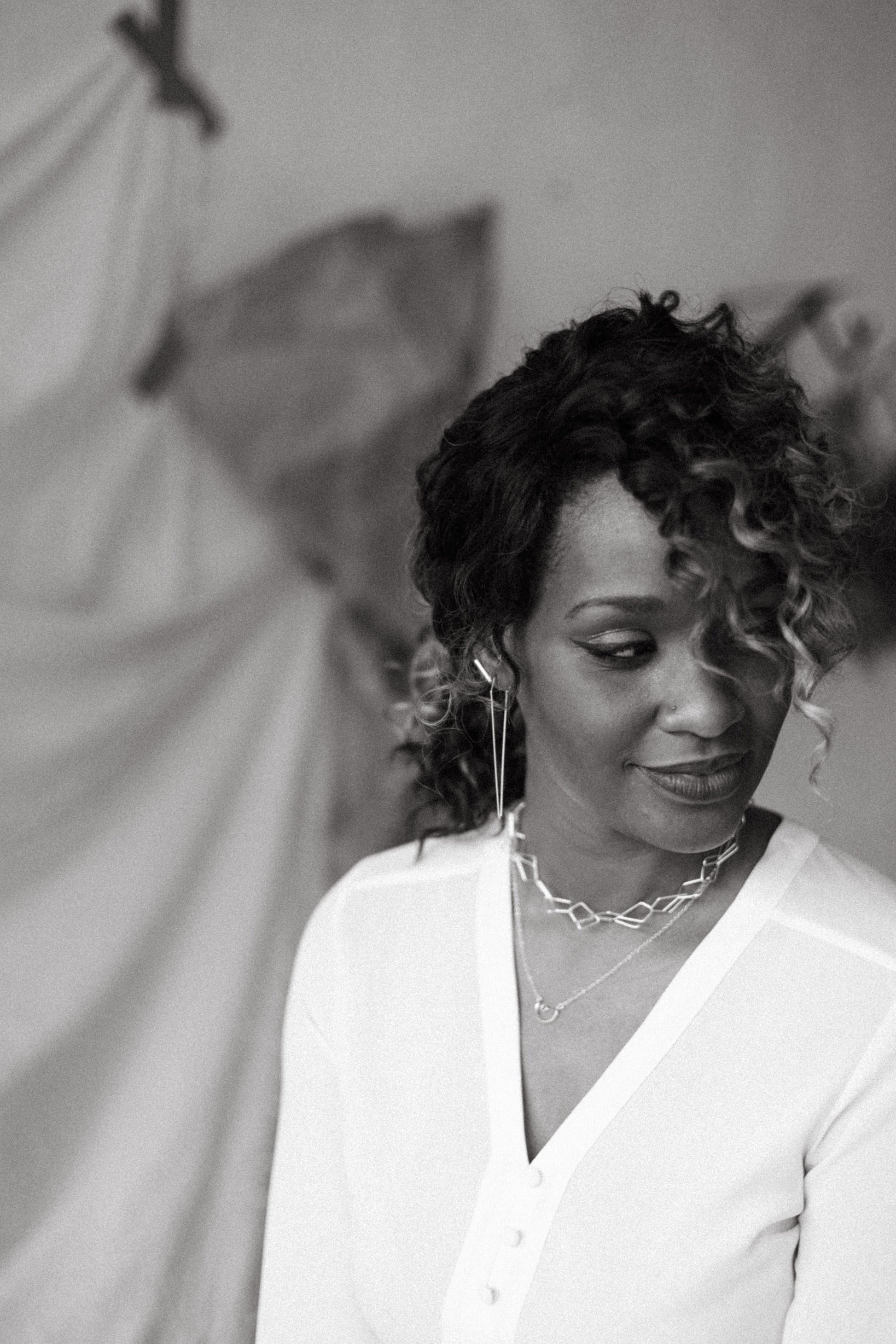 model wearing silver dagger hoops and open diamond necklaces