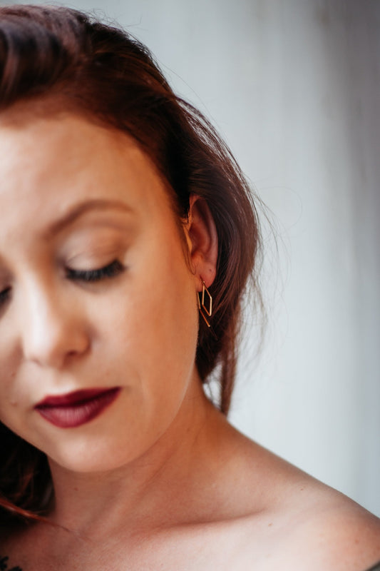 Rose gold diamond pull-through hoops styled on model