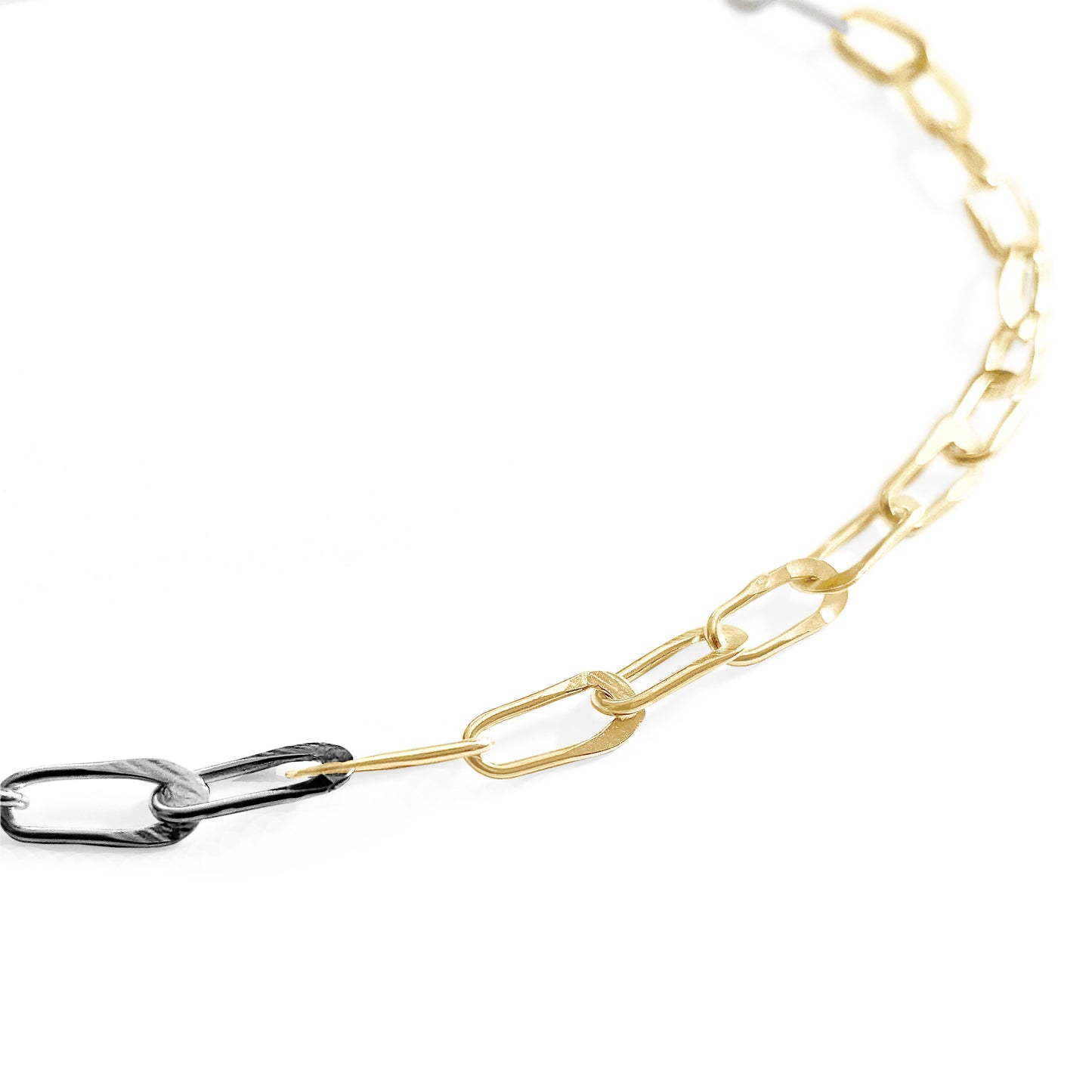 Gold and silver chain necklace on a white background