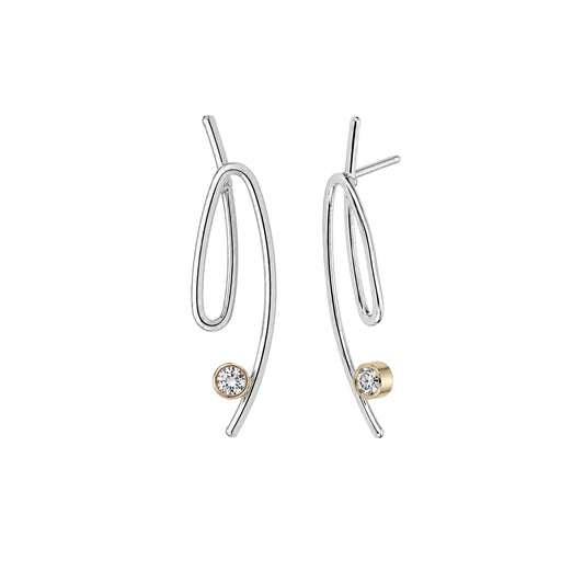 A pair of modern abstract drop earrings in polished silver-tone metal with a small round gold bezel-set clear gemstone at the bottom of each earring, shown on a plain white background.