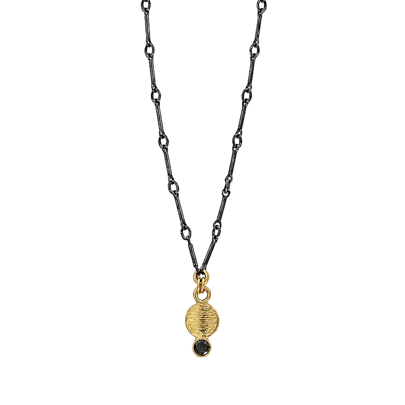 A delicate black chain necklace featuring a textured gold circular pendant with a small black bead dangling below it, set against a plain white background.