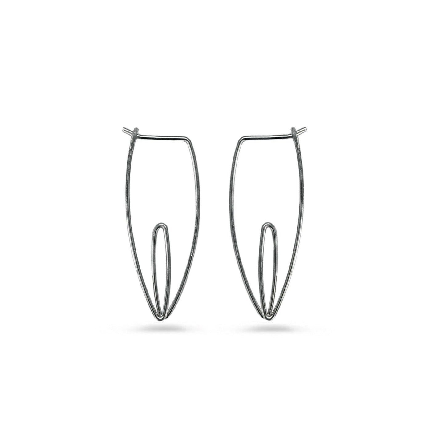 Pair of minimalist black floral hoop earrings on a white background