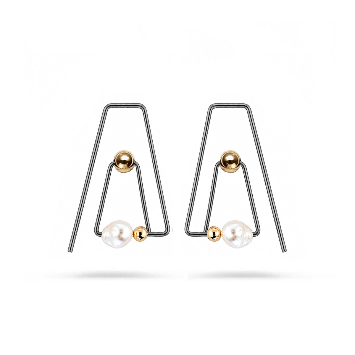 A pair of black triangle hoops each with gold beads and one small baroque pearl on white background.