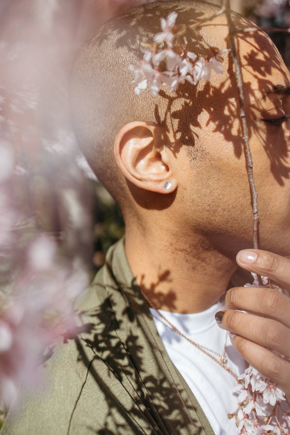 Silver stud earrings styled on model