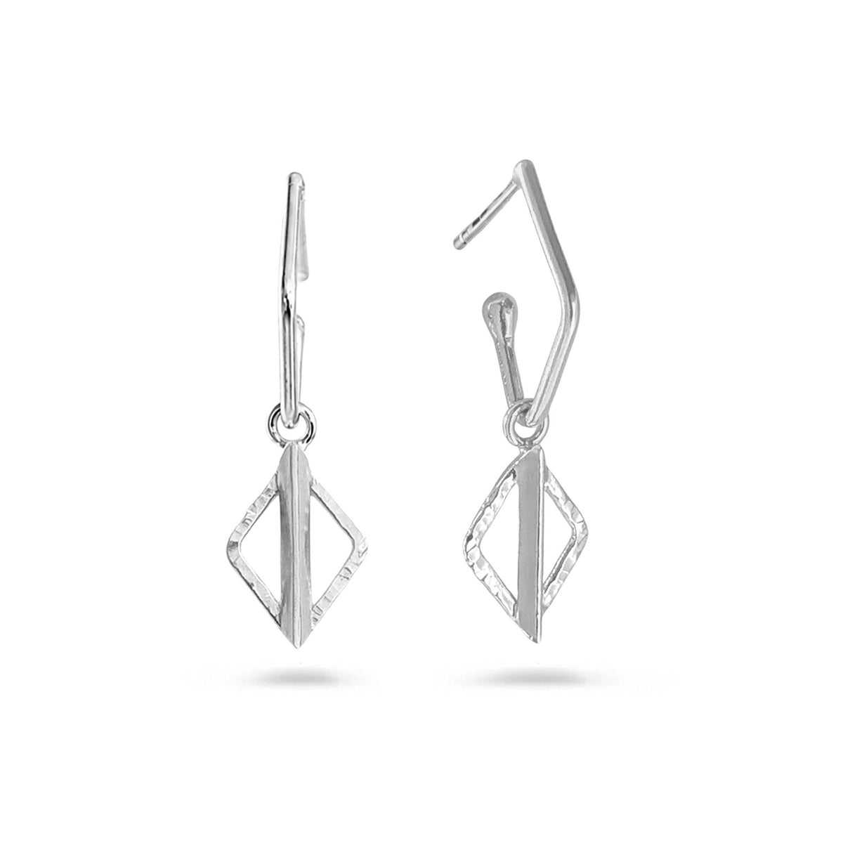 A pair of silver geometric drop earrings with a textured diamond-shaped pendant and a curved hook back, shown on a clean white background.