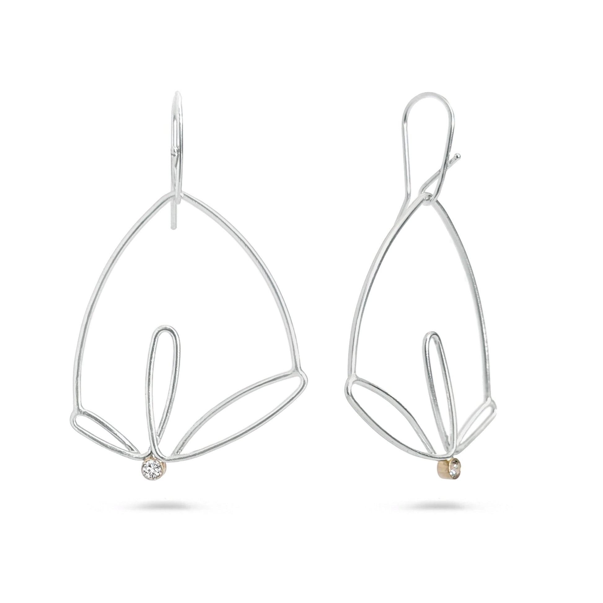 Pair of silver leaf-shaped earrings on a white background