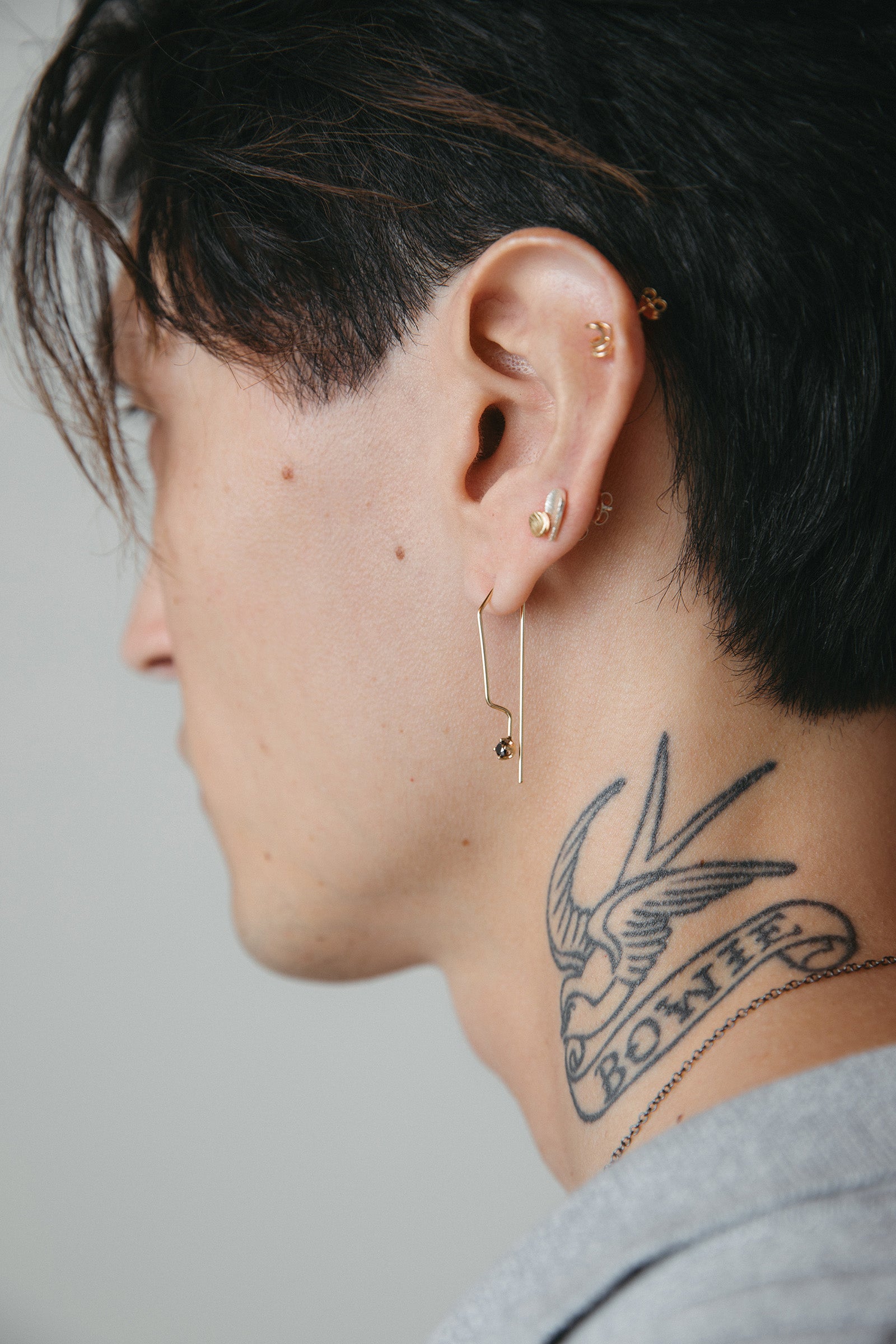 Fine geometric 14K gold wire hoop earring with black diamonds