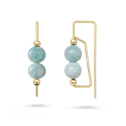 Gold earrings with light blue beads on a white background