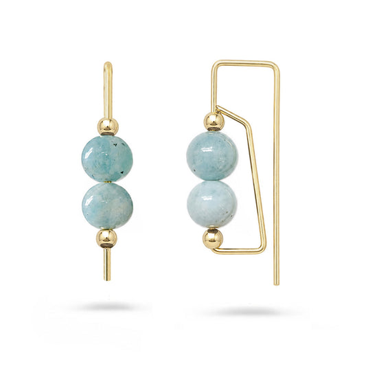 Gold earrings with light blue beads on a white background