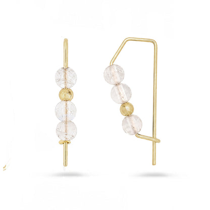 Gold hoops with stacked rose quartz gemstone beads on white background