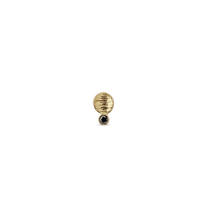 single small textured gold disk stud with a black diamond
