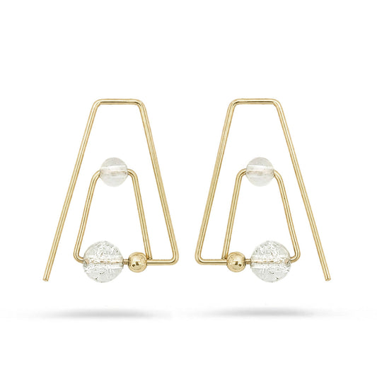 Gold earrings with spherical elements on a white background