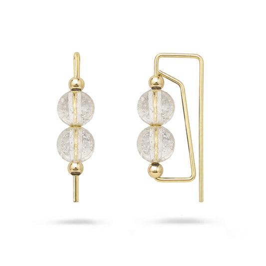 Gold earrings with clear gemstones on a white background