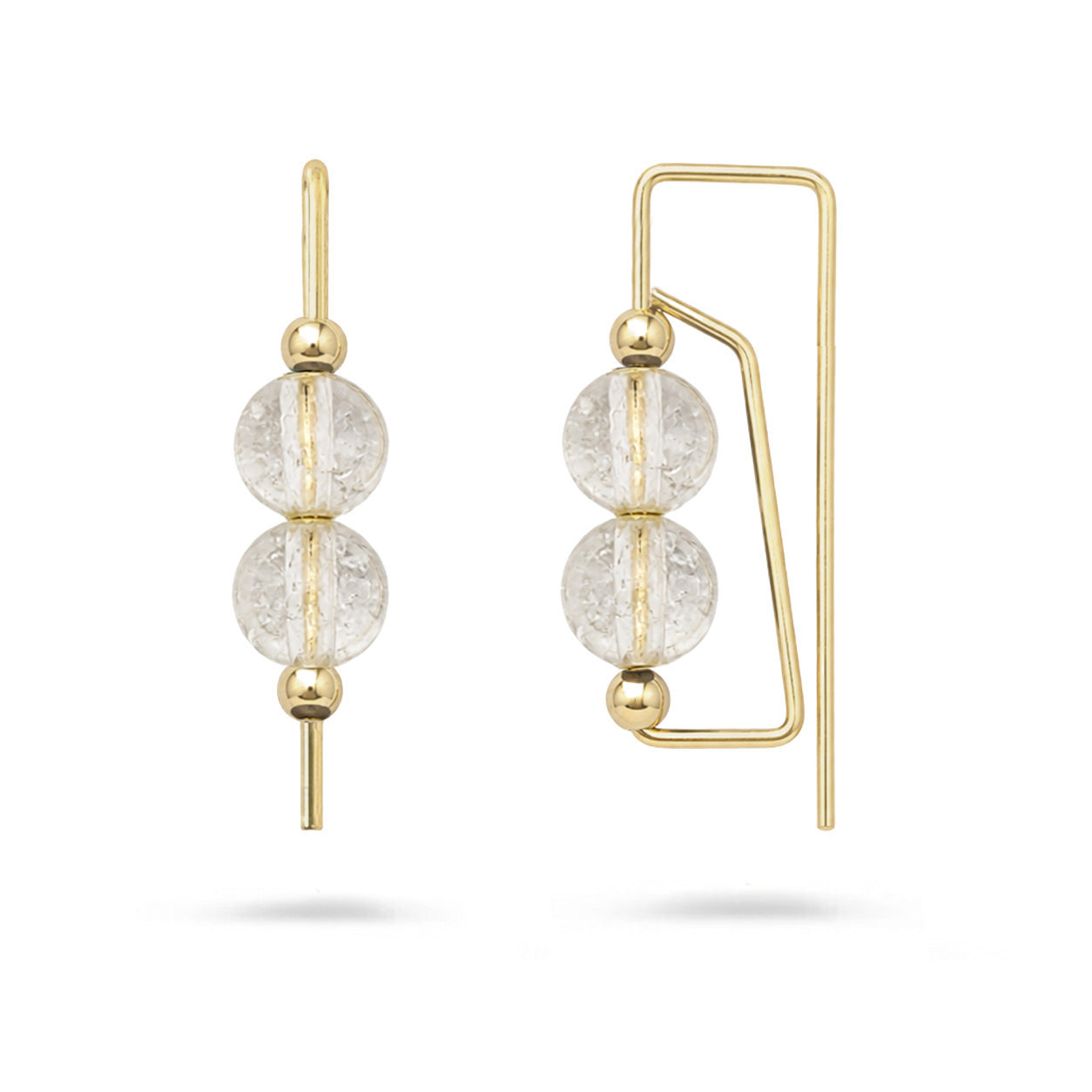 Gold earrings with clear gemstones on a white background