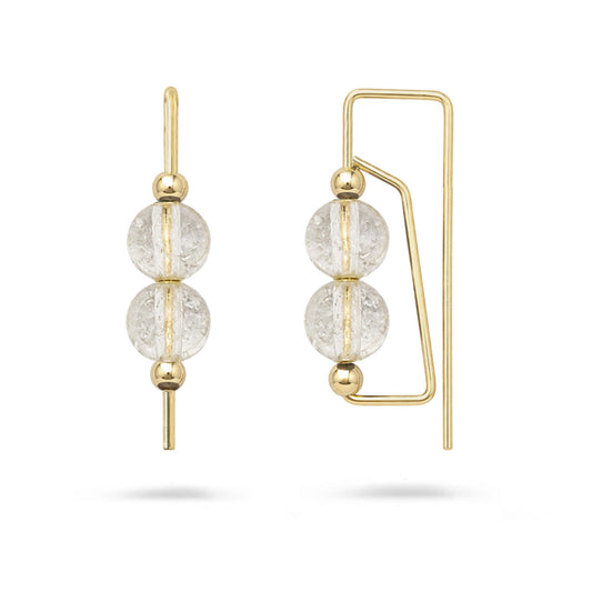 Gold earrings with clear gemstones on a white background