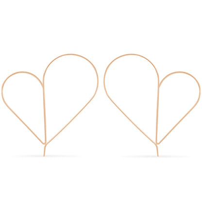 Two rose gold heart-shaped hair accessories on a white background