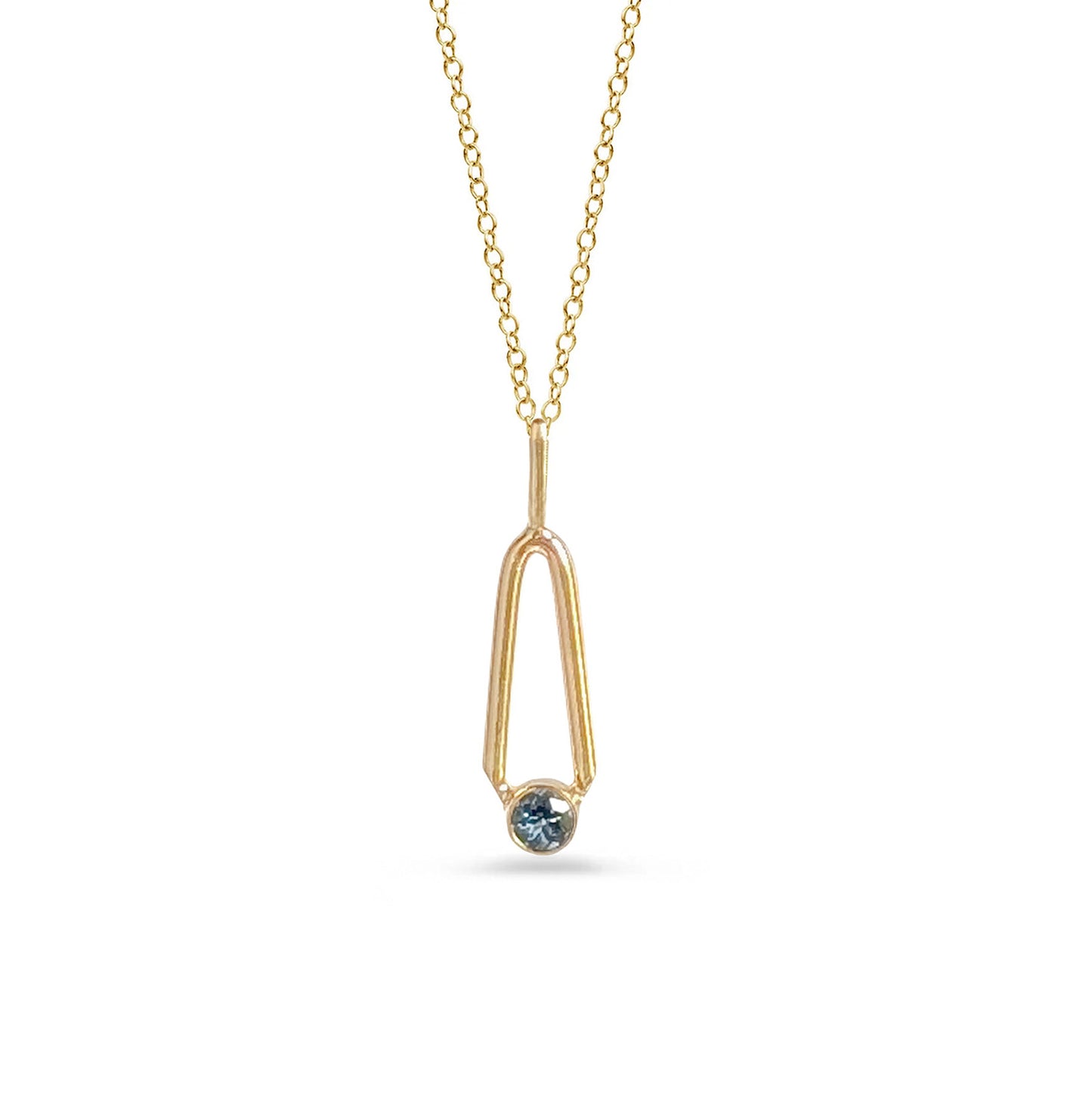 Gold necklace with a blue gemstone pendant on a white background