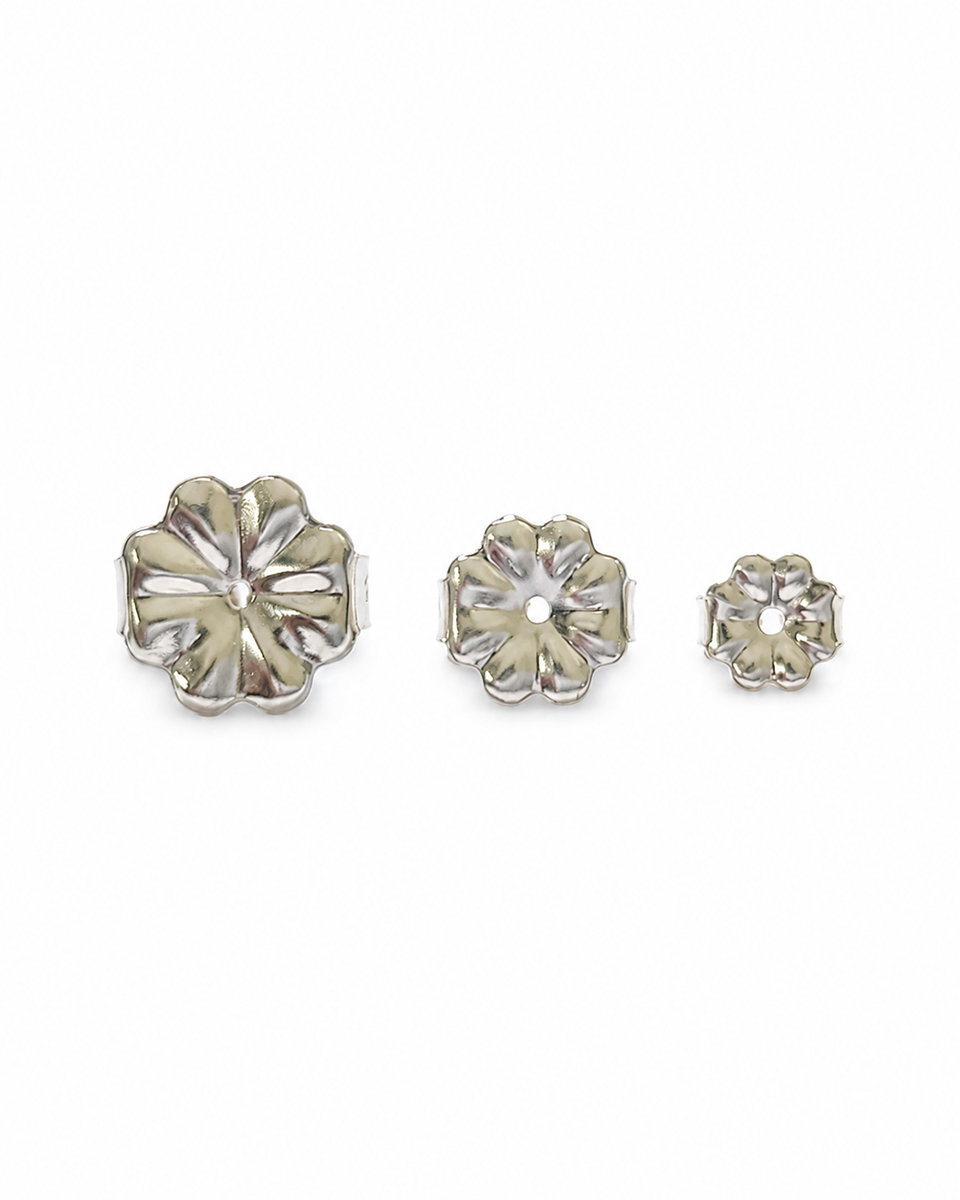 Several sterling silver 9mm, 7mm and 5mm earring backs laid out on a white surface.
