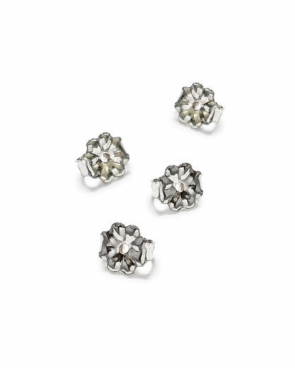 Four silver flower-shaped 5mm earring backs arranged on a plain white background.