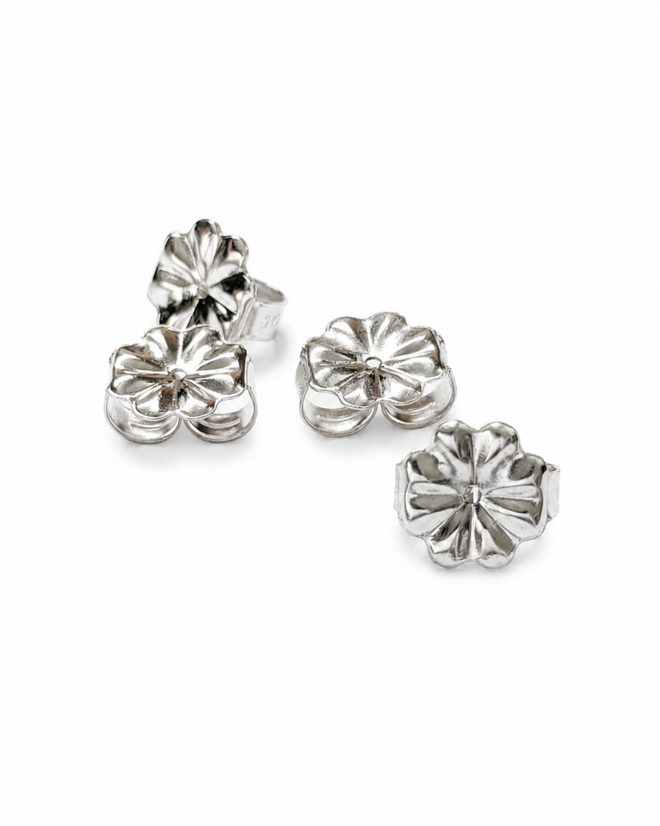 Four silver flower-shaped 9mm earring backs arranged on a plain white background.