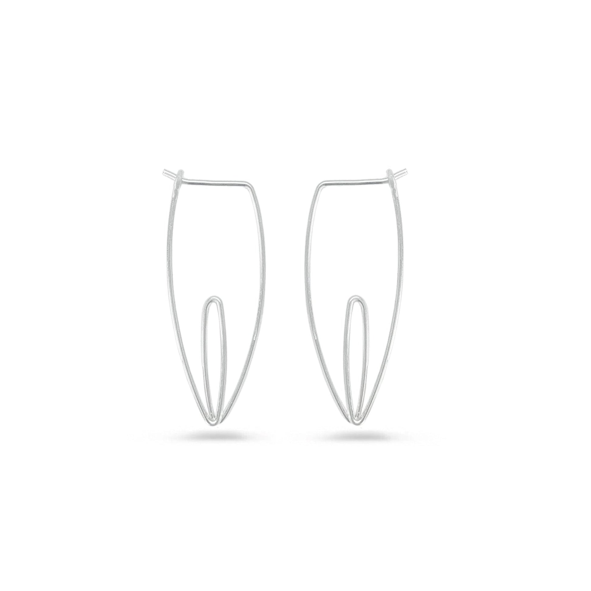 A pair of small silver lily flower hoop earrings on a white background