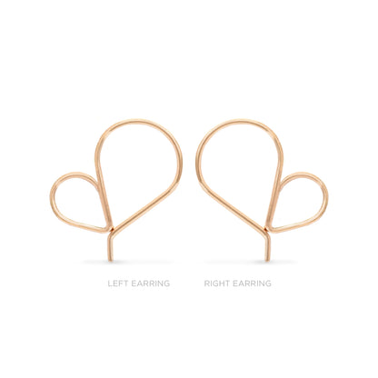Pair of single rose gold heart shaped hoop earrings on a white background