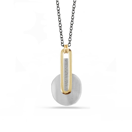 Silver disk and long 14k gold oval with textured silver inside, attached to charcoal silver chain