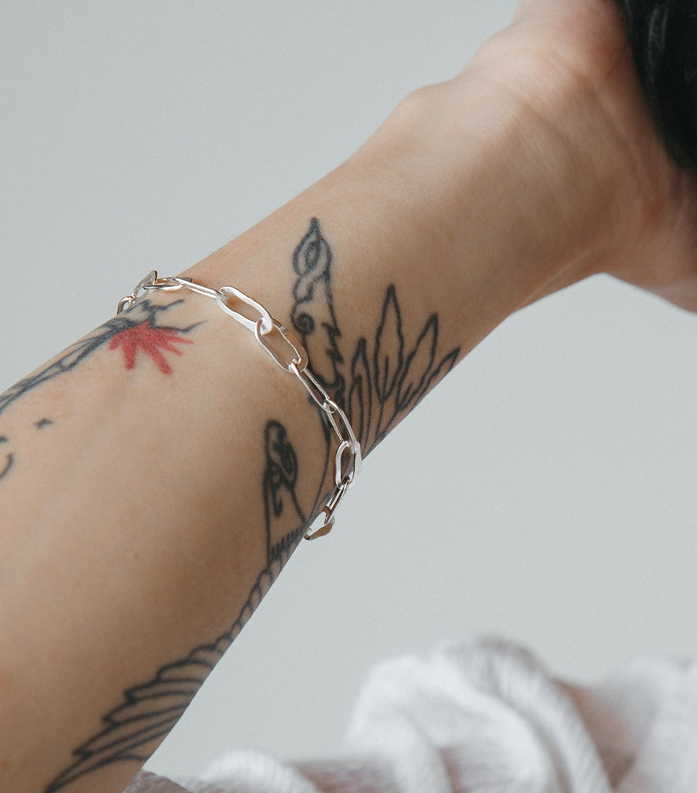 model wearing silver hammered oval link bracelet