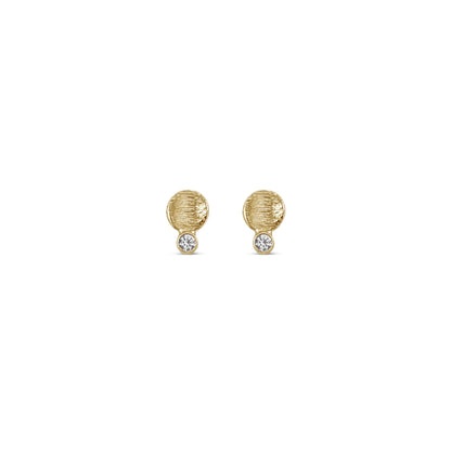small textured gold disk studs with a diamond connected to the bottom edge