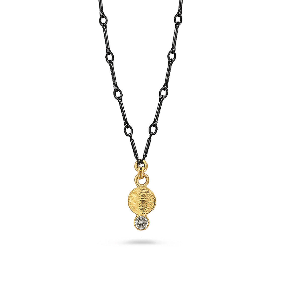 A gold pendant necklace and white diamond suspended on a black chain against a white background.