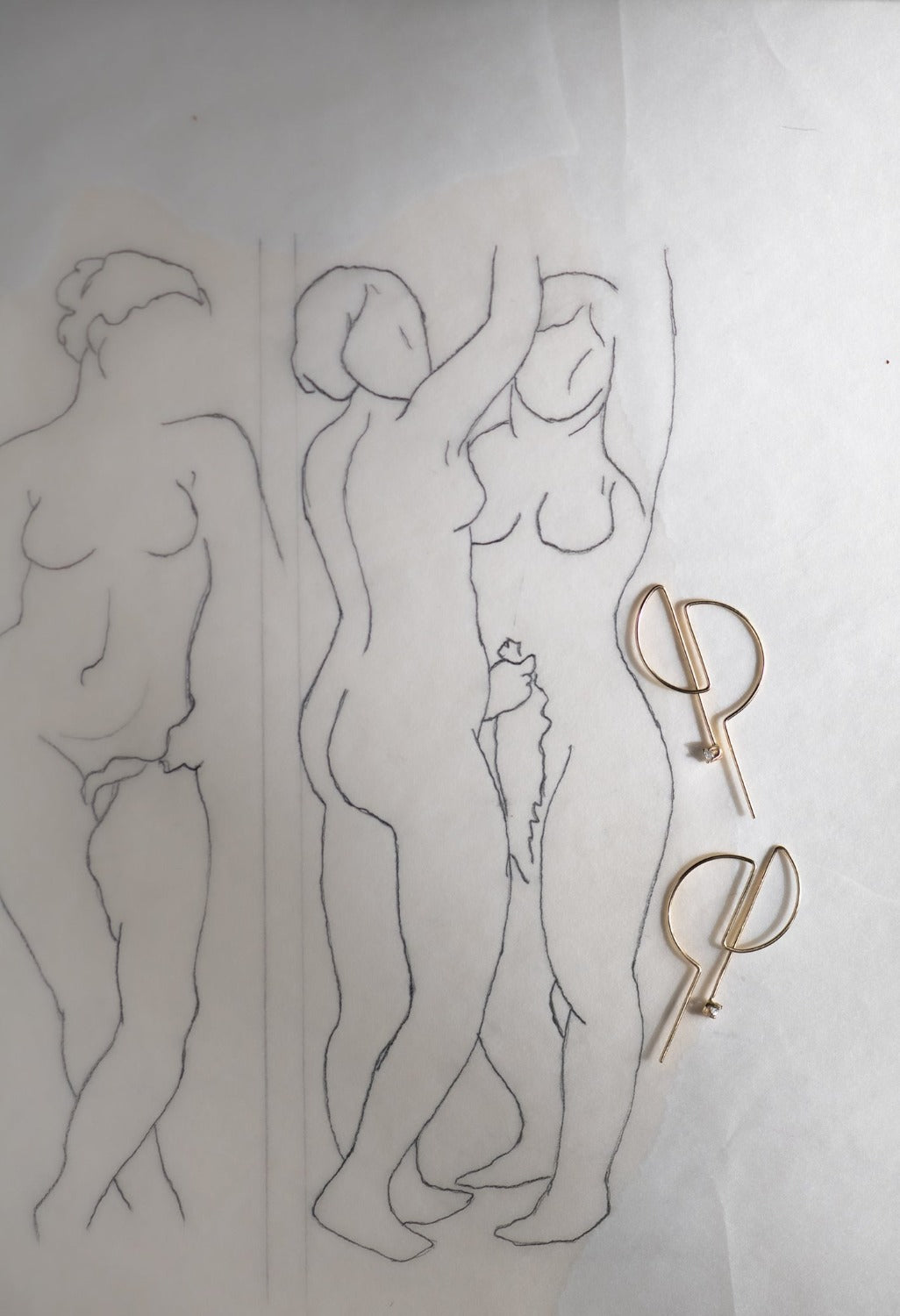 14K gold D hoop earrings with artist line drawing