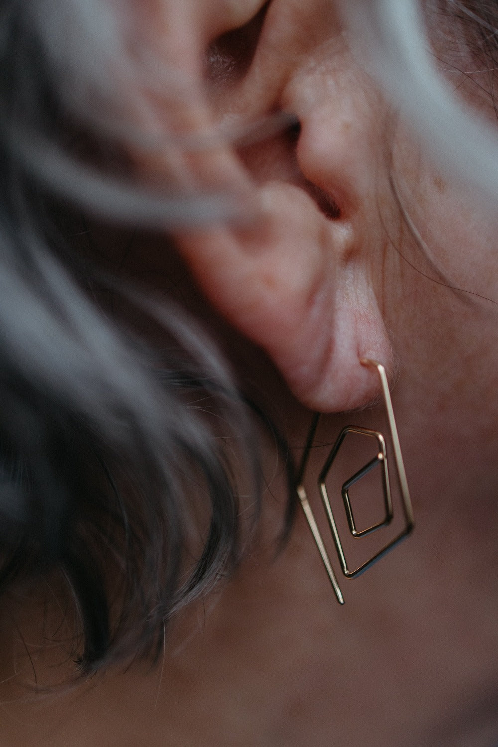 model wearing spiral diamond wire earrings